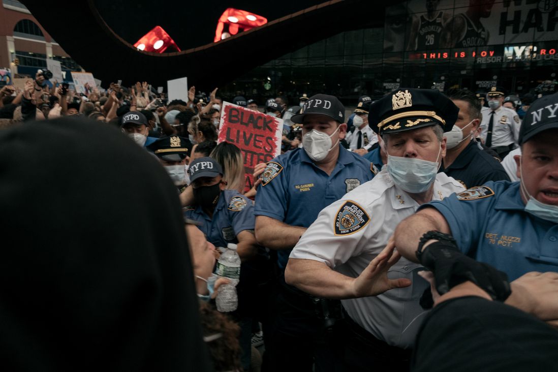 NYPD officers shove protesters back outside Barclays Center.